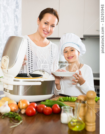 mother and daughter using multicooker 18293948