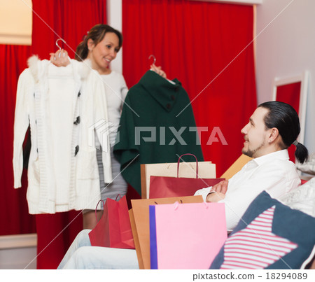couple choosing jacket at clothing store couple choosing jacket at clothing store 18294089