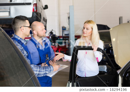 Two mechanics trying to cheat client at workshop Two mechanics trying to cheat client at workshop 18294196