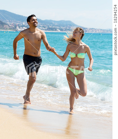 family running on the shore family running on the shore 18294254