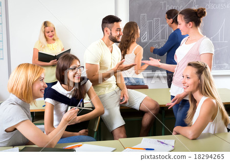 Group of students chatting in classroom 18294265