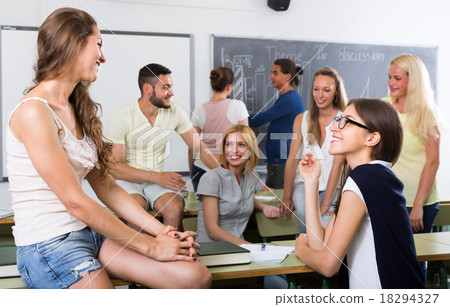 students chatting while sitting in the room 18294327