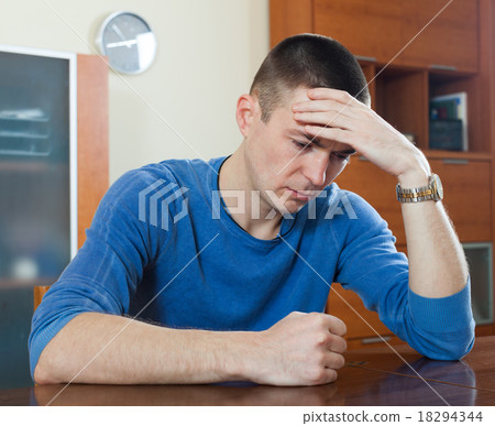 Unhappy guy in home Unhappy guy in home 18294344
