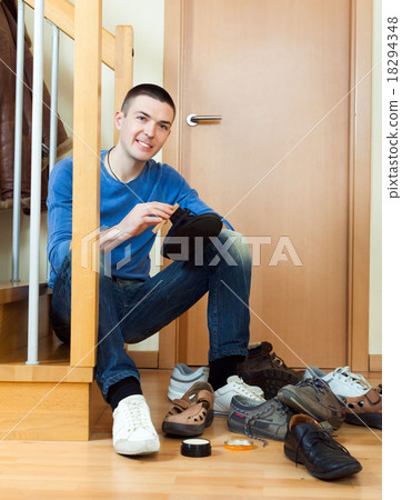 Young man woman cleaning shoes Young man woman cleaning shoes 18294348