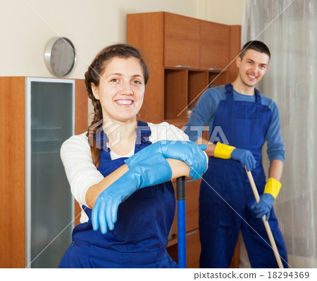 Happy cleaners team cleaning floor 18294369