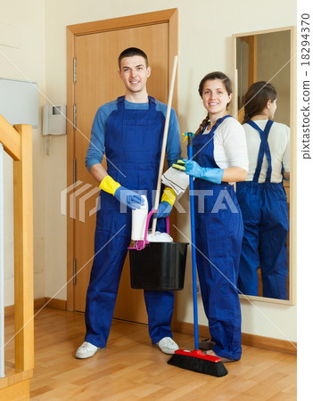 Smiling cleaners cleaning room 18294370