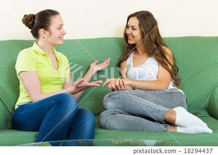 Two casual women gossiping Two casual women gossiping 18294437