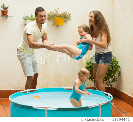 Family playing in pool at terrace 18294441