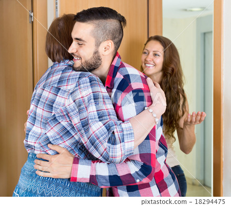 Happy young couple hugging mother Happy young couple hugging mother 18294475
