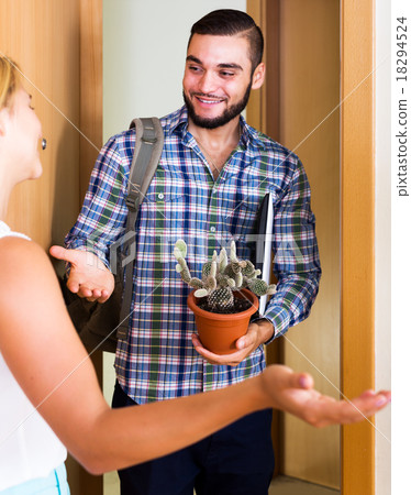 Welcomes guests at the entrance 18294524