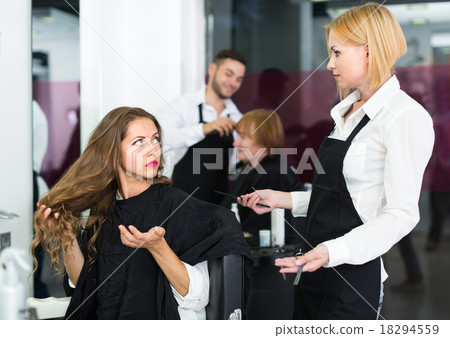 Displeased client and hairdresser. Displeased client and hairdresser. 18294559