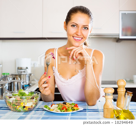 Positive female eating healthy salad 18294649