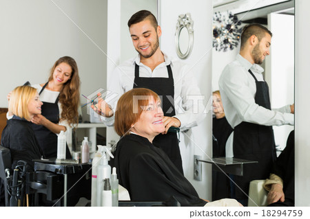 Elderly woman cuts hair at the hair salon Elderly woman cuts hair at the hair salon 18294759