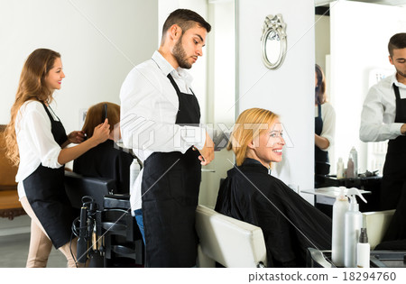 Hairstylist making a haircut in barbershop Hairstylist making a haircut in barbershop 18294760