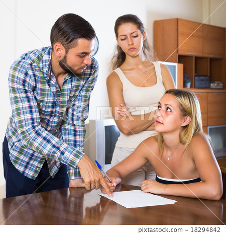 Three adults with papers. 18294842