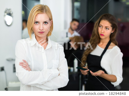 Displeased client and hairdresser. Displeased client and hairdresser. 18294848