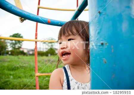 child playing on playground equipment in the park 18295933