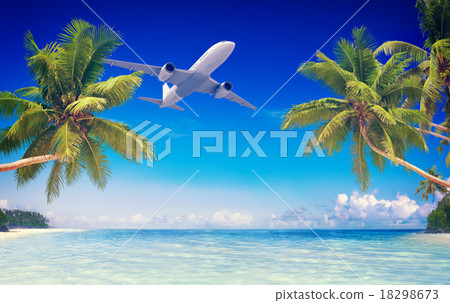 Airplane Flying Over Tropical Beach Travel Concept 18298673