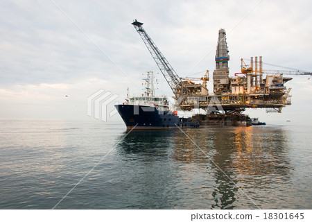 Oil rig being tugged in the sea Oil rig being tugged in the sea 18301645
