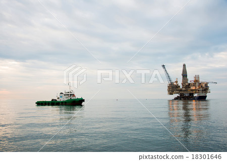 Oil rig being tugged in the sea Oil rig being tugged in the sea 18301646