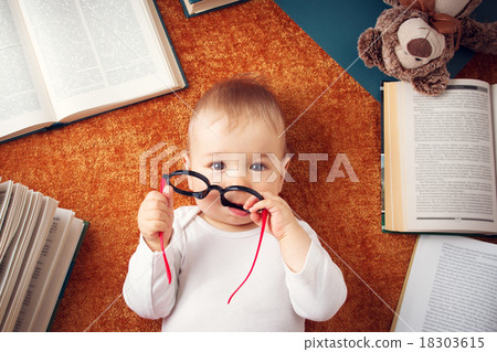 One year old baby with spectackles and a teddy One year old baby with spectackles and a teddy 18303615