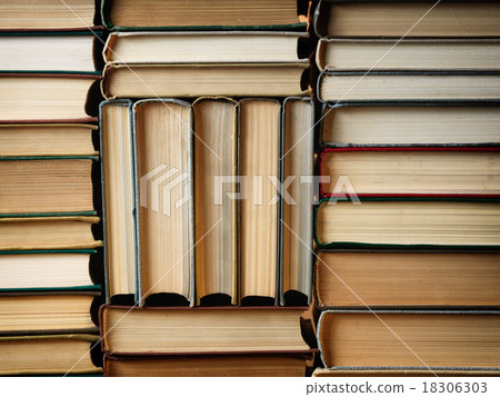 Background made of old books arranged in stacks 18306303