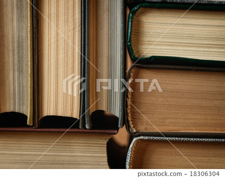 Background made of old books arranged in stacks Background made of old books arranged in stacks 18306304