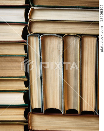 Background made of old books arranged in stacks 18306305