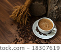 Cup of coffee with beans in earthy setting 18307619