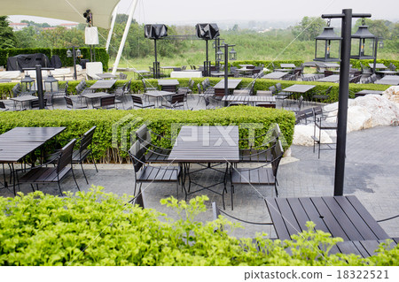 Outdoor restaurant open air chairs with table. 18322521