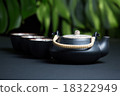 Black ceramic teapot with cups and steam 18322949