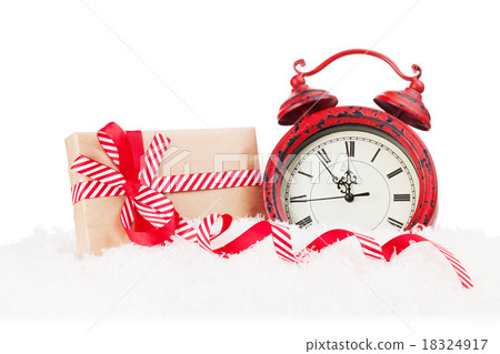 Christmas gift box and alarm clock in snow Christmas gift box and alarm clock in snow 18324917