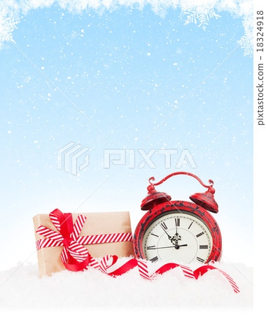 Christmas gift box and alarm clock in snow Christmas gift box and alarm clock in snow 18324918