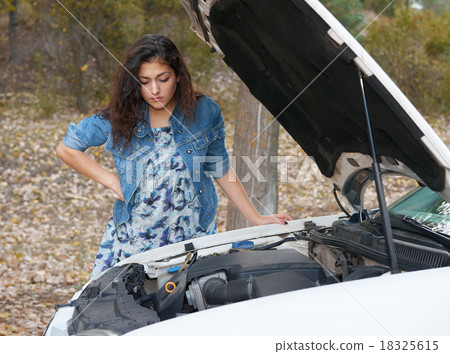 Woman with broken car wait on road 18325615