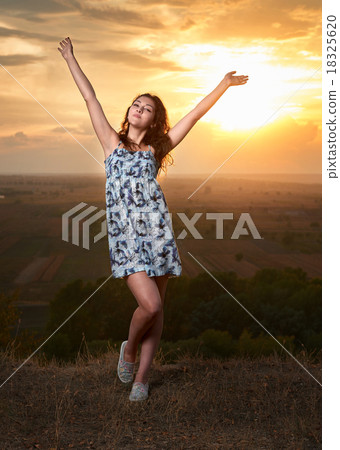 girl open arms at sunset on plain background girl open arms at sunset on plain background 18325620
