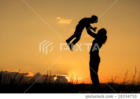 Mother and son playing on the coast of lake 18334710