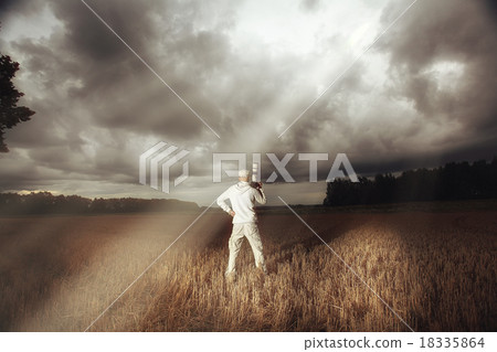 photographer with a camera in the bad weather the storm 18335864