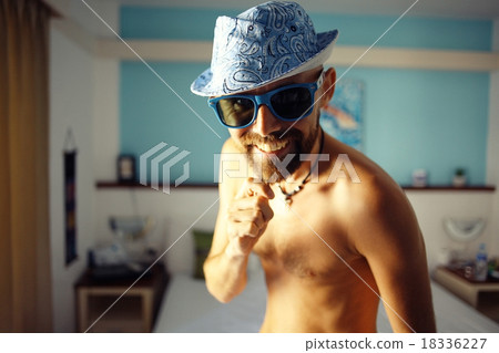 portrait of a tanned guy in a hotel in sunglasses 18336227