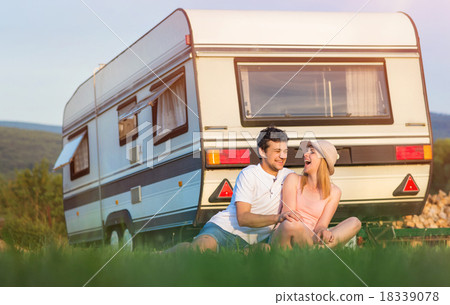 Stock Photo: Young couple in front of a camper van