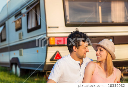 Young couple in front of a camper van 18339082
