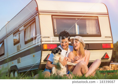 Stock Photo: Young couple in front of a camper van