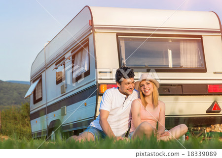 Stock Photo: Young couple in front of a camper van