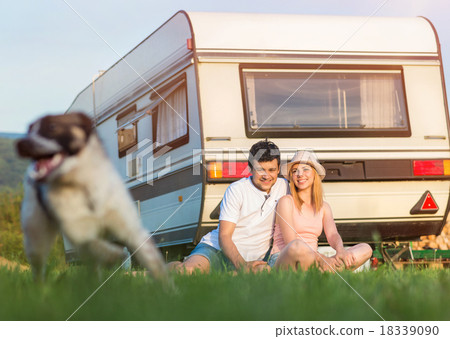 Stock Photo: Young couple in front of a camper van