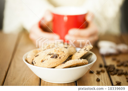 Cookies and woman holding a cup 18339609