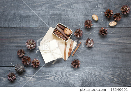 Gift, card, pine cones and cinnamon on the table 18340601