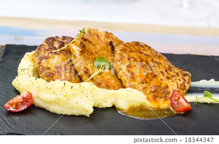 cutlets fried in carrot sauce with mashed potatoes cutlets fried in carrot sauce with mashed potatoes 18344347