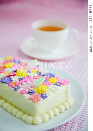 Colorful cake served with a hot tea. 18346781