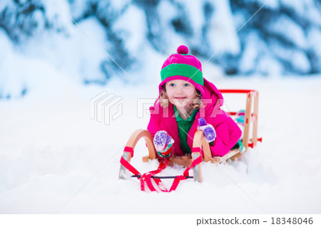 Little girl playing in snowy winter forest Little girl playing in snowy winter forest 18348046