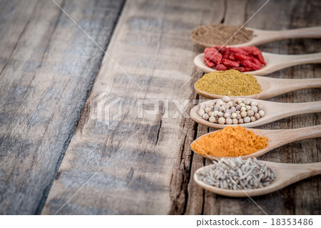 Collection of spices on a wooden spoon 18353486