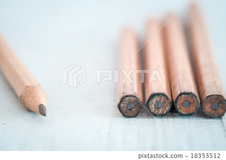 Old pencil on a light blue wooden desk 18353512